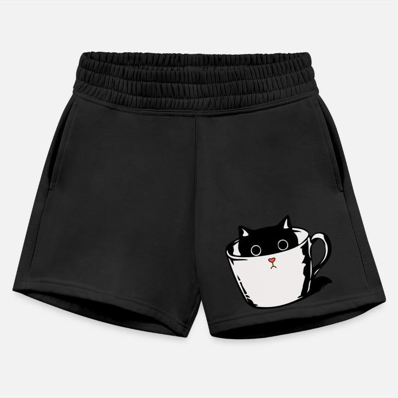 Black kitten with red nose hiding in a cup